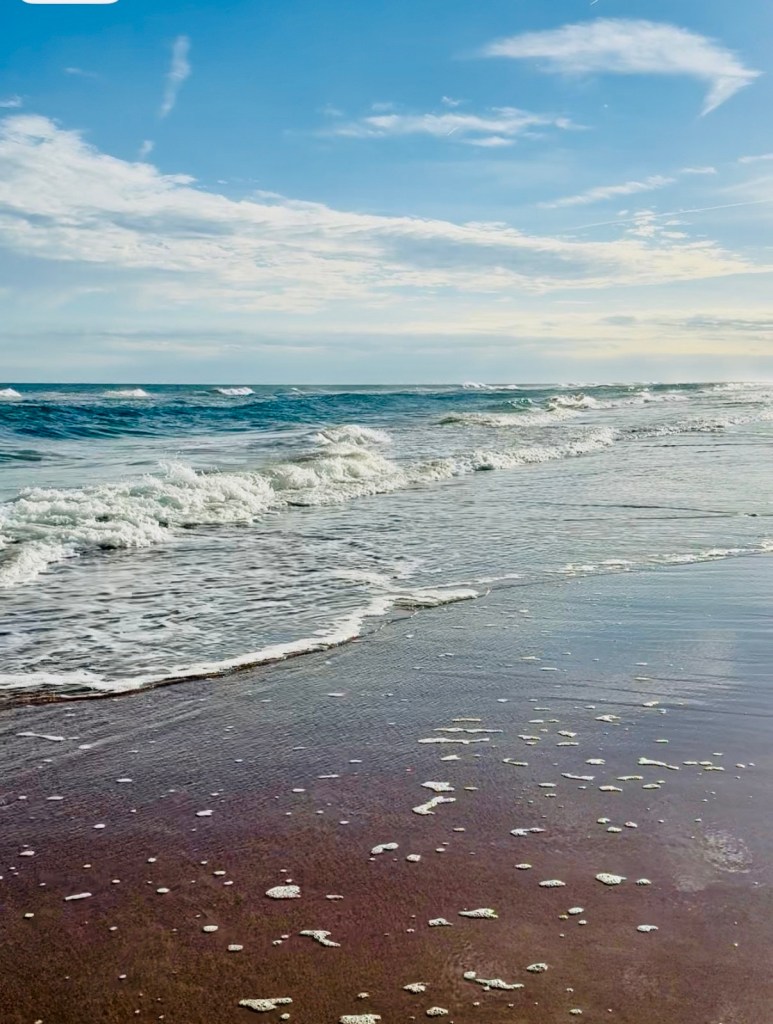 Waves rolling gently toward shore beneath an open sky, symbolizing the freedom and breath of Real Jesus after captivity.